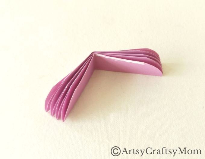 Spruce up your room or living space with this pretty paper flower wreath craft! It's easy enough for kids to make, and all you need is craft paper!