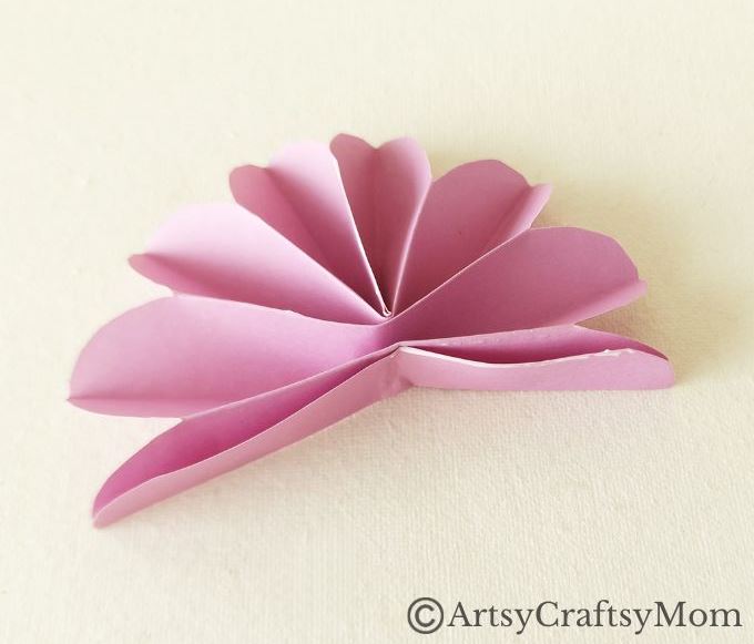 Spruce up your room or living space with this pretty paper flower wreath craft! It's easy enough for kids to make, and all you need is craft paper!