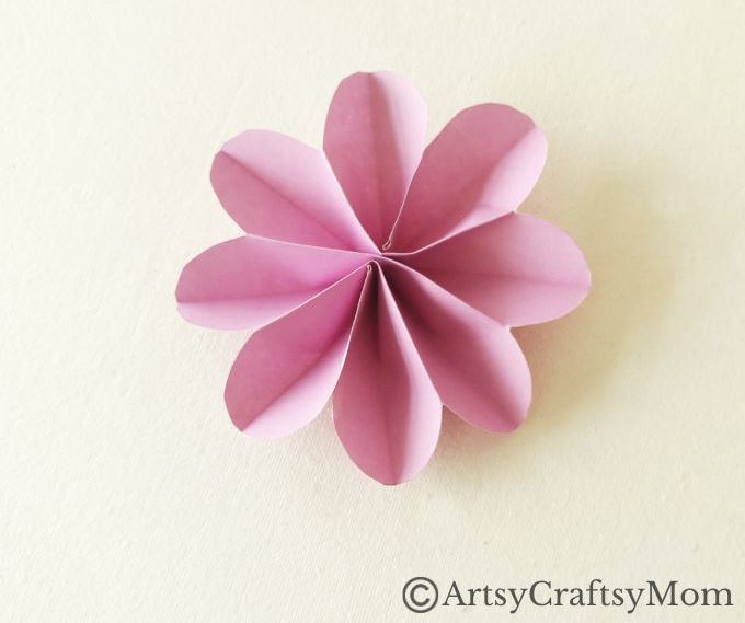 Spruce up your room or living space with this pretty paper flower wreath craft! It's easy enough for kids to make, and all you need is craft paper!