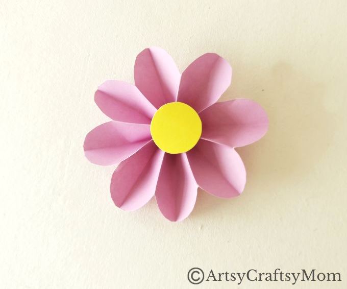 Spruce up your room or living space with this pretty paper flower wreath craft! It's easy enough for kids to make, and all you need is craft paper!