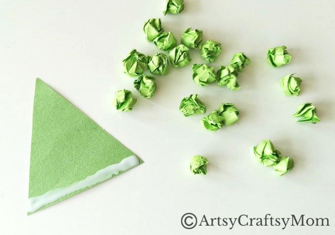 This crumpled paper Christmas tree ornament is the easiest Christmas craft for kids to try this holiday season - all you need is lots of green paper!