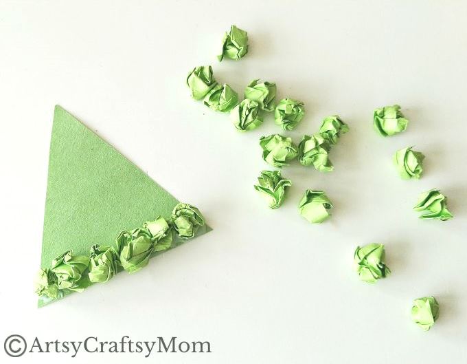This crumpled paper Christmas tree ornament is the easiest Christmas craft for kids to try this holiday season - all you need is lots of green paper!