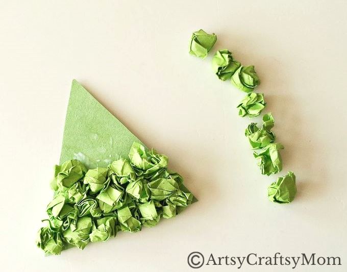 This crumpled paper Christmas tree ornament is the easiest Christmas craft for kids to try this holiday season - all you need is lots of green paper!