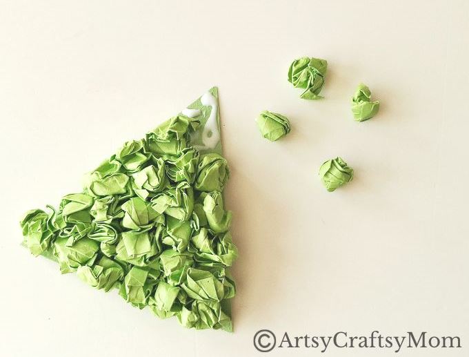 This crumpled paper Christmas tree ornament is the easiest Christmas craft for kids to try this holiday season - all you need is lots of green paper!