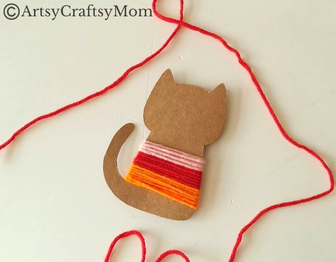 Colorful Yarn-Wrapped Cat Craft for Kids 8 This colorful yarn wrapped cat craft is great for young kids to practice their fine motor skills while also keeping them focused for a bit!
