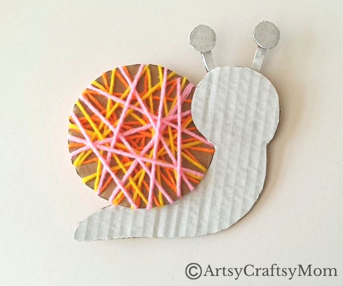Here's a beautiful yarn-wrapped snail craft for kids to help exercise their fine motor skills and also help them focus intently on a task for a while!