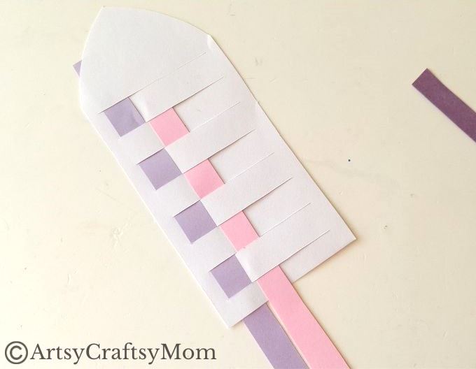 New to paper weaving? This colorful woven paper rocket craft is the perfect choice for little kids starting out, without overwhelming them!