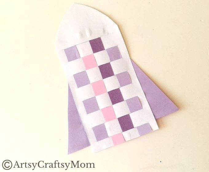 New to paper weaving? This colorful woven paper rocket craft is the perfect choice for little kids starting out, without overwhelming them!