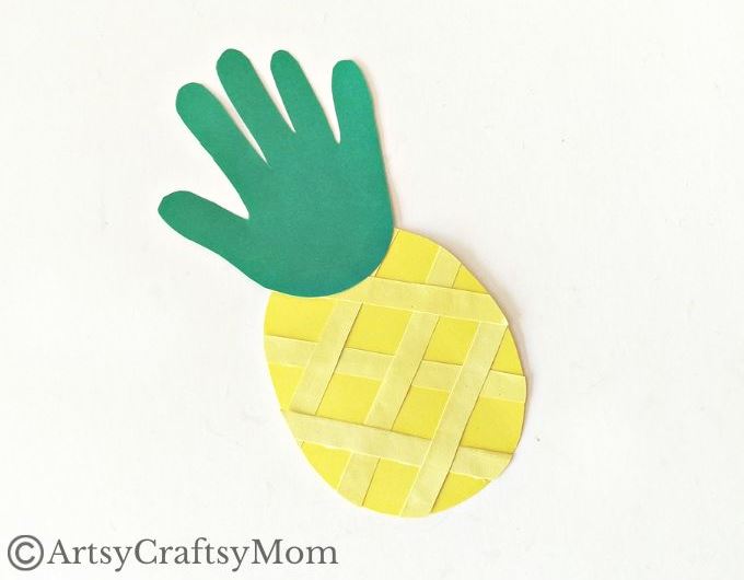 This juicy handprint pineapple craft for kids is perfect for the summer and looks good enough to eat! Ideal project for young kids and preschoolers!