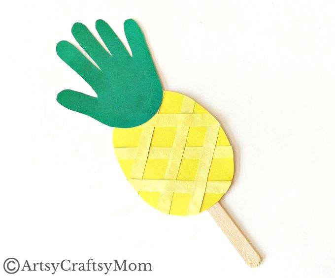 This juicy handprint pineapple craft for kids is perfect for the summer and looks good enough to eat! Ideal project for young kids and preschoolers!