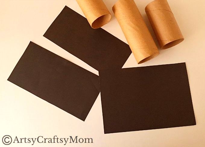 Gather all the empty cardboard tubes you can find - we're going to use them and some craft paper to make a toilet paper roll haunted house craft!